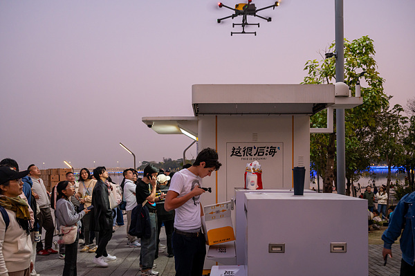 在深圳，外國游客體驗無人機外賣送餐。