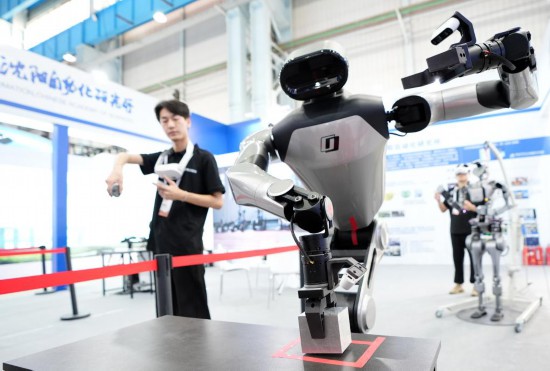 9月5日，在沈陽的2025全球工業(yè)互聯(lián)網(wǎng)大會的展覽區(qū)現(xiàn)場，中國科學院沈陽自動化研究所的機器人工程師在調試具身智能操作系統(tǒng)。新華社記者 李鋼 攝